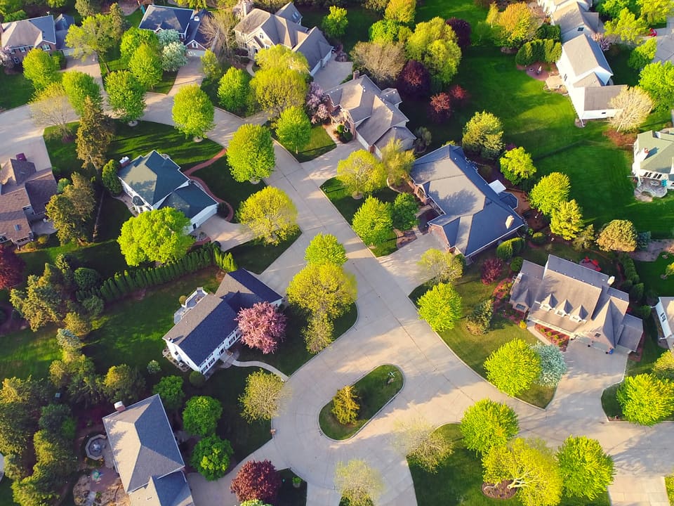 An aerial view of a North Texas residential community with new and established homes.